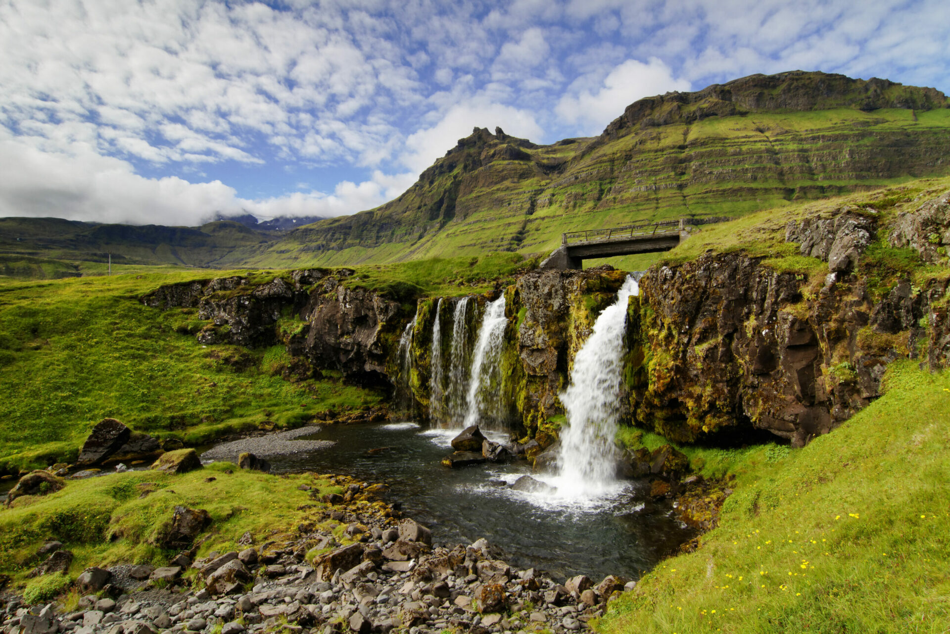 Snæfellsnes waterfall and green mountain landscape