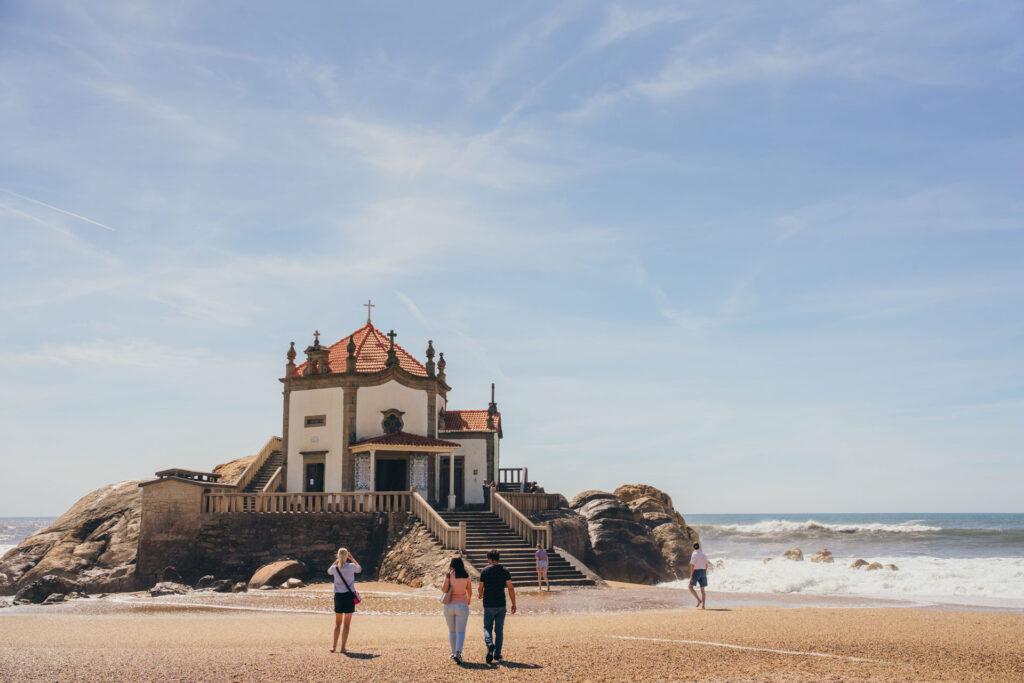 A church on the beach in Portugal with tourist