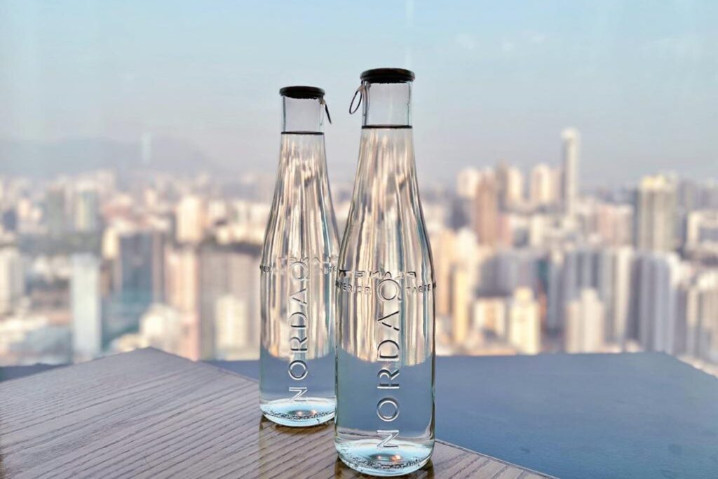 Two bottles of Nordaq FRESH in front of the Hong Kong skyline