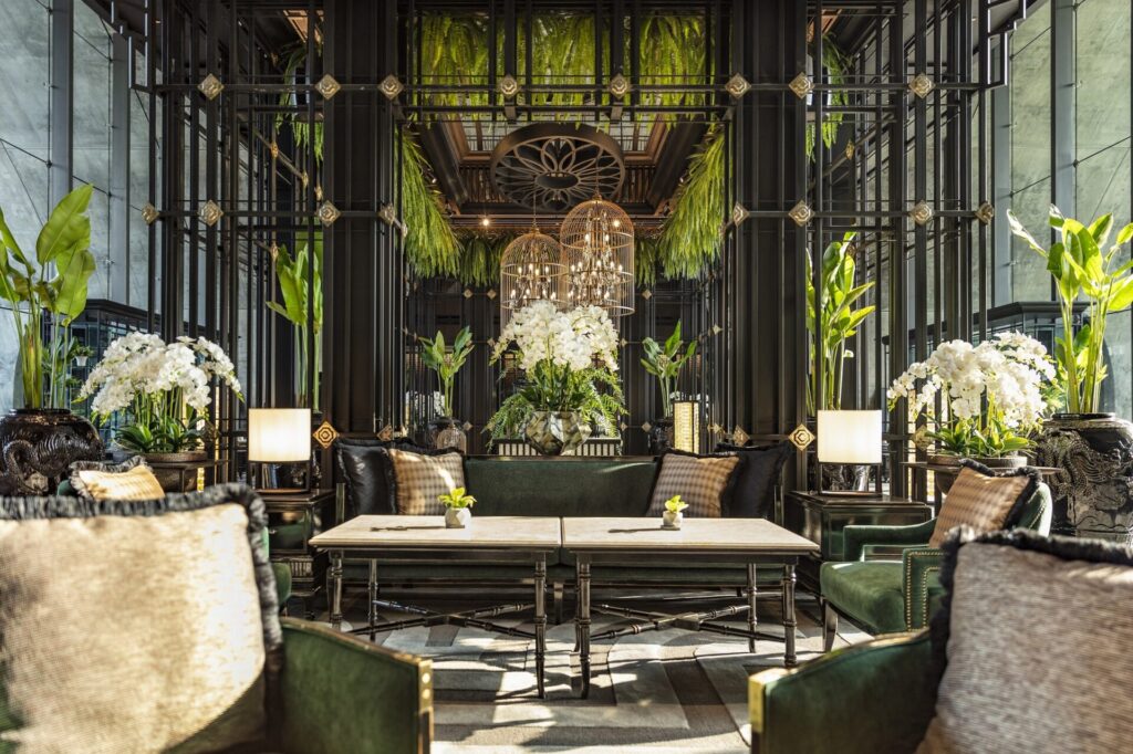 A hotel lobby surrounded by green plants.