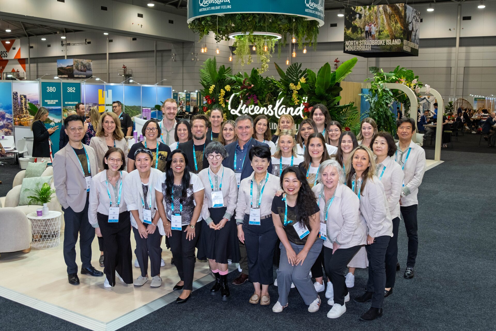 TEQ Group Staff Photo in front of Queensland booth at ATE