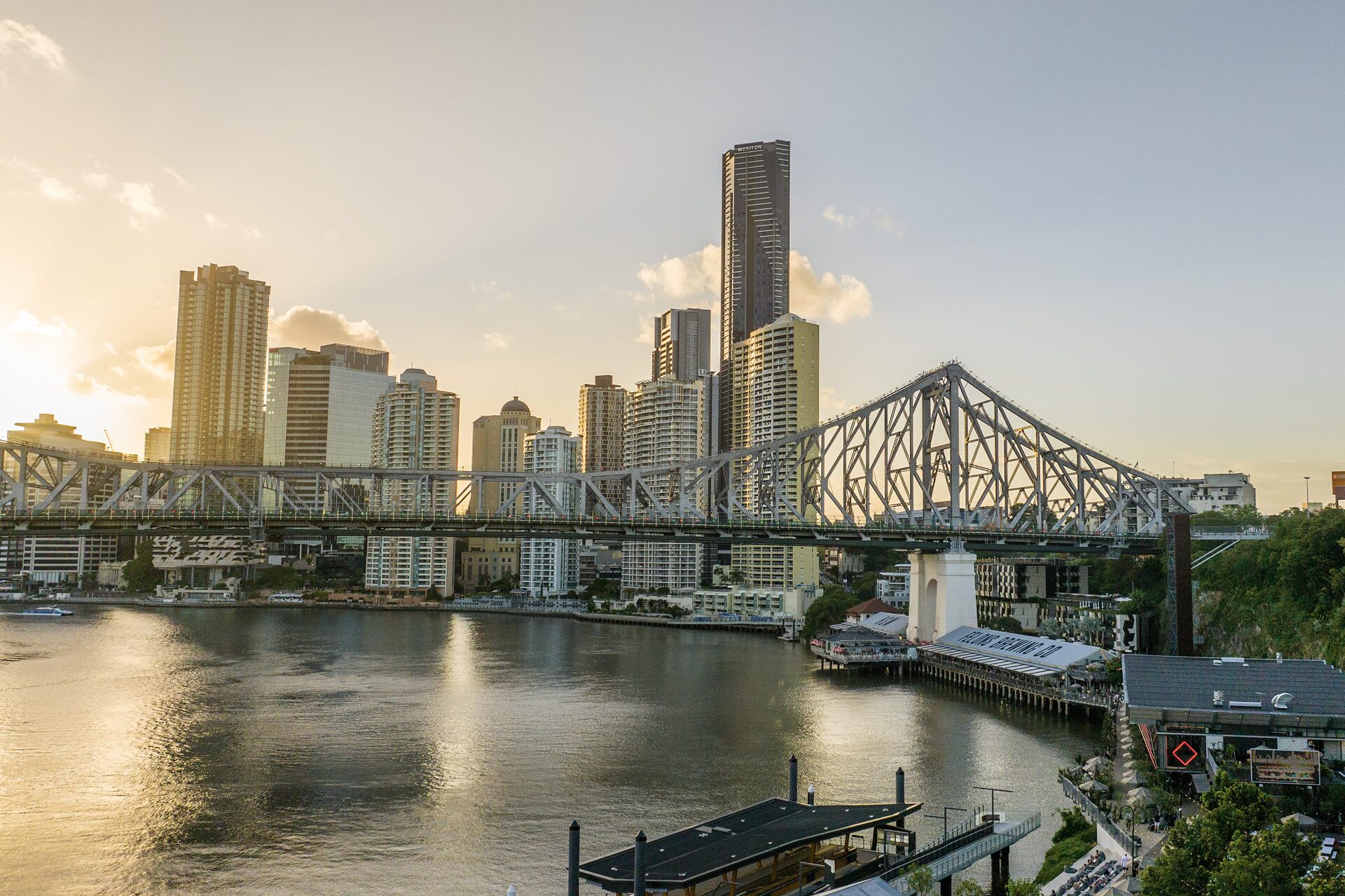 The sun setting over the Story Bridge with Brisbane City in the background