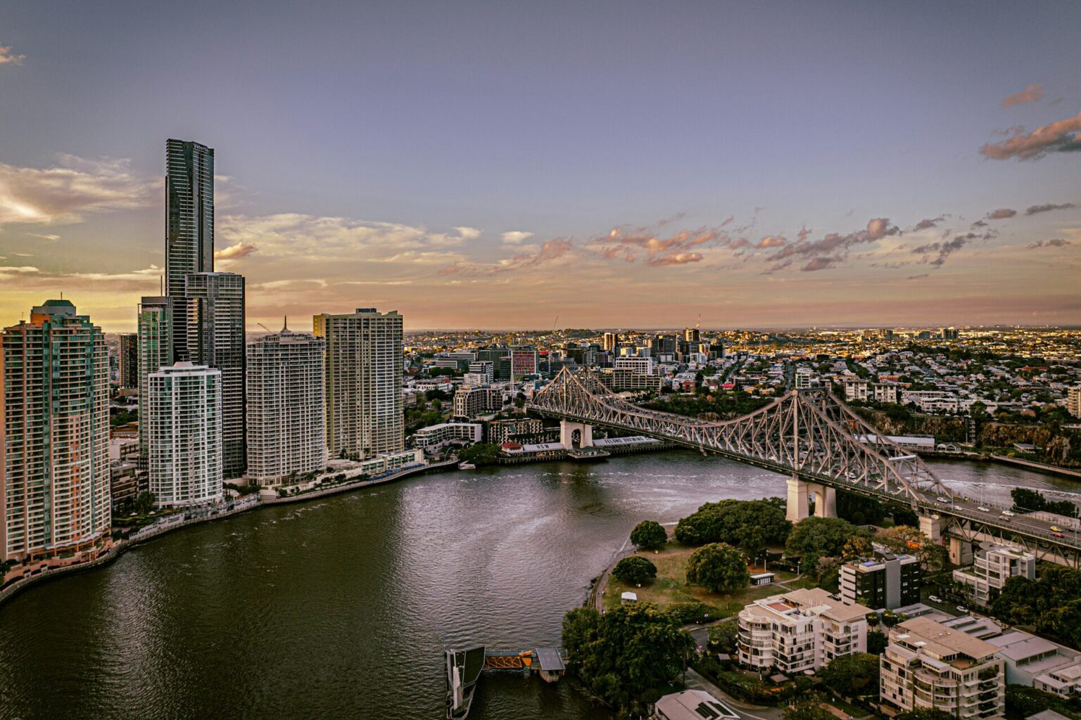 Brisbane skyline at sunset, aerial view over skyscrapers, river and Story Bridge