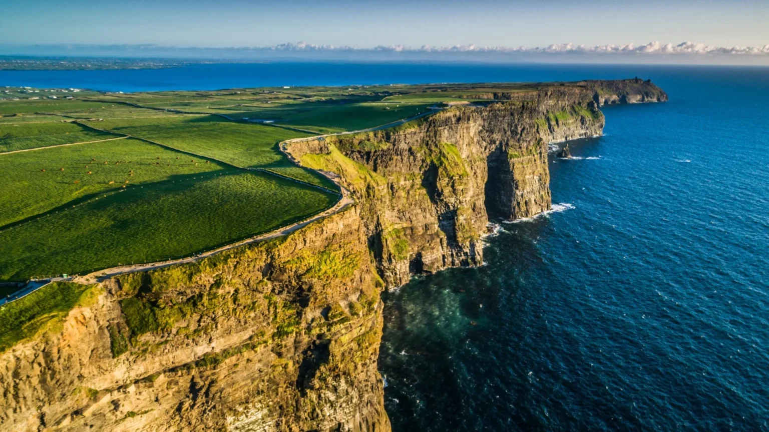 Aerial photo of the Cliffs of Moher along the sea in Ireland