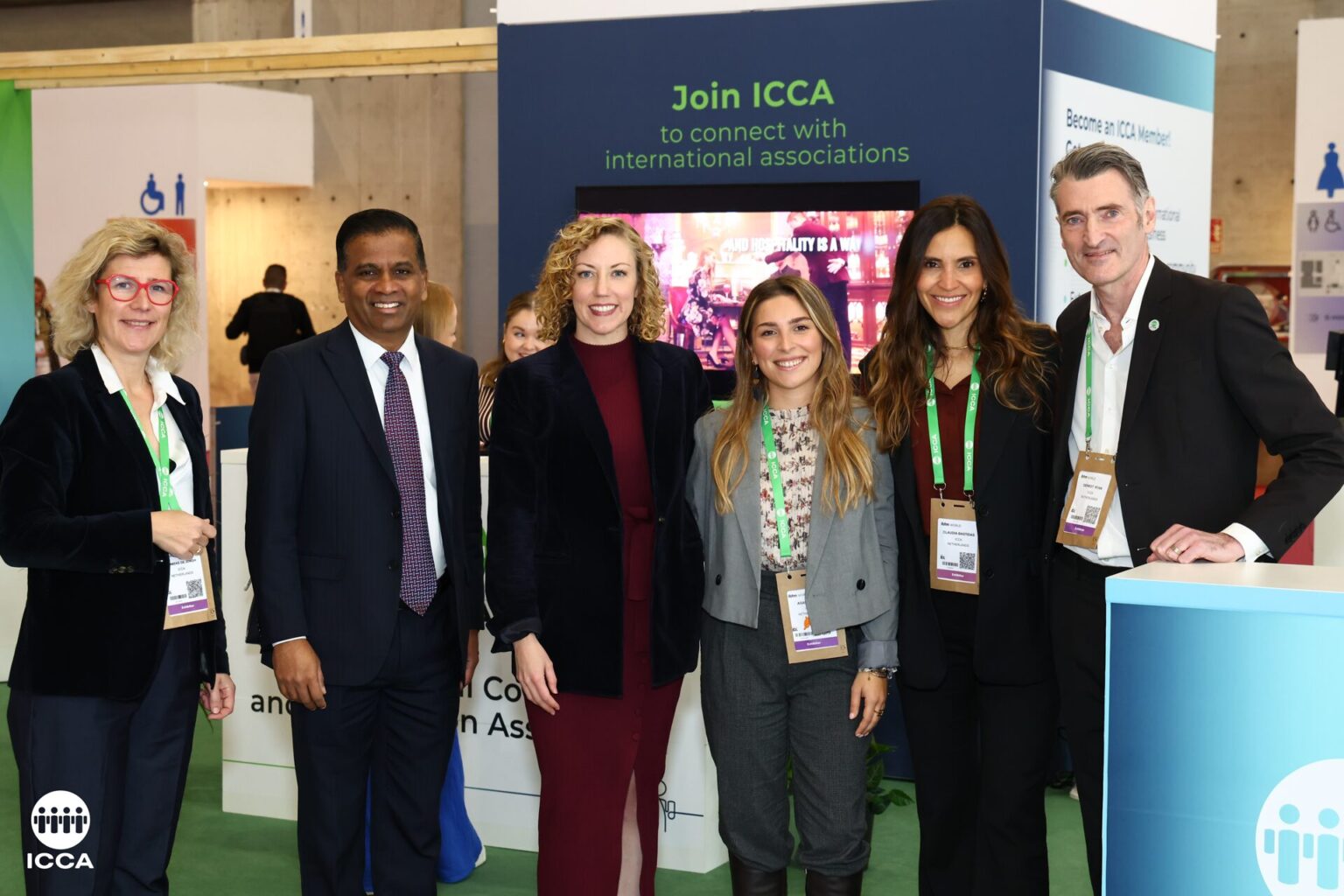 EarthCheck and ICCA representatives posing for a photo in front of an ICCA stand