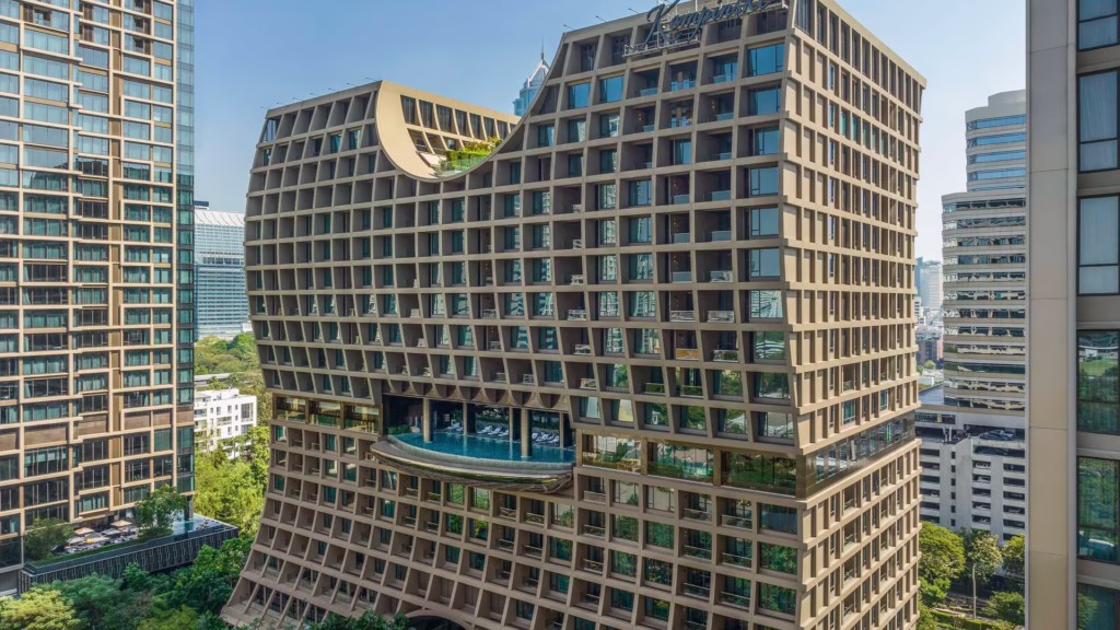 Exterior of hotel with pool in the middle