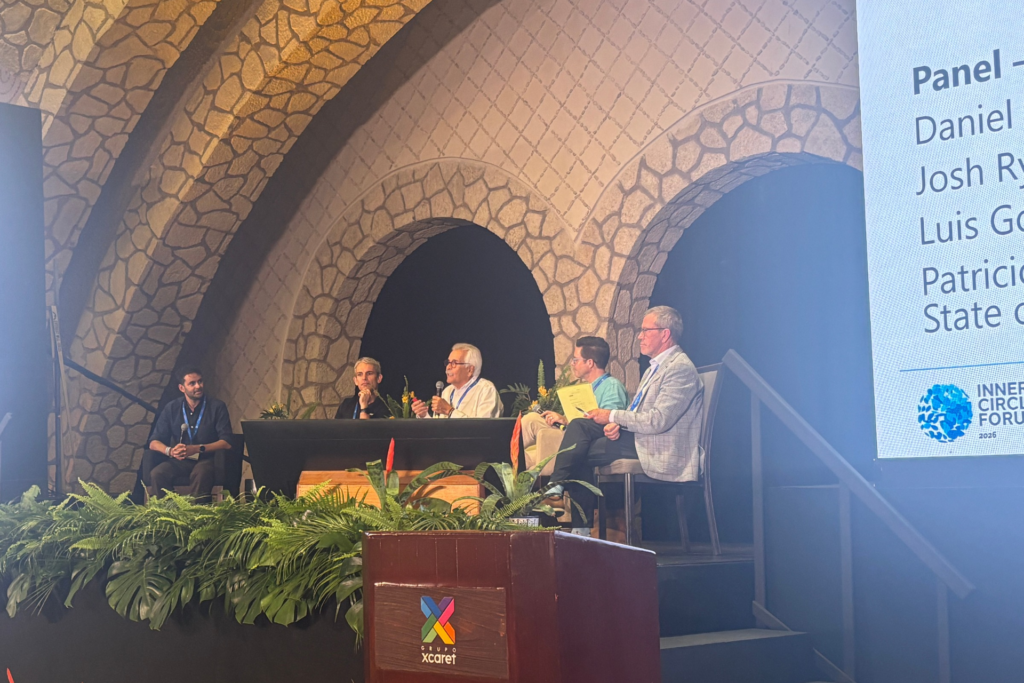Panel of five people sitting on stage speaking at Inner Circle Forum
